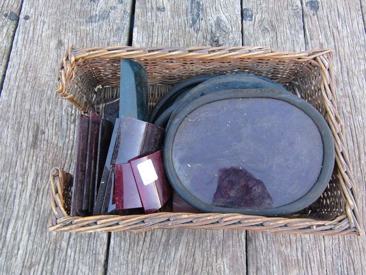 A quantity of different coloured railway aspects for signals and lamps contained in a wicker