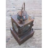 A railway signal lamp interior with reservoir and burner,