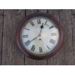 A late 19th Century mahogany carved railway waiting room wall clock with blade Roman numerals to
