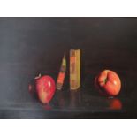 A framed still life oil on canvas of apples and books on a table, indistinctly signed bottom left,