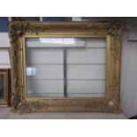 A 19th Century ornate gilt frame decorated with foliate detail and scrolls. Some molding missing.