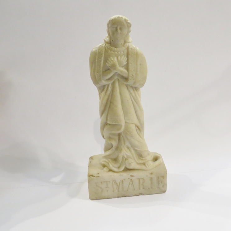A 17th Century carved alabaster figure of Saint Marie