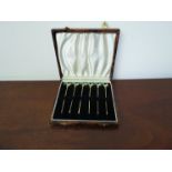 A set of six sterling silver cocktail sticks with enamel cockerel finials in original case