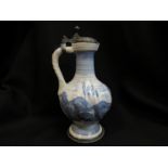 A 19th Century German faience jug and cover, restored,
