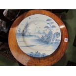 An 18th Century Liverpool Delft charger, external scene of figure fishing,