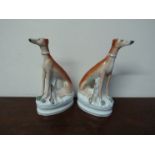 A pair of 19th Century Staffordshire greyhounds with open legs