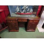 A circa 1860 mahogany breakfront desk the tooled leather insert over three frieze drawers on single