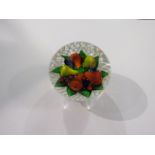 A Saint Louis paperweight "Piedouche basket of fruit on white latticinio base",