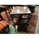 An Edwardian inlaid mahogany revolving bookcase on stand