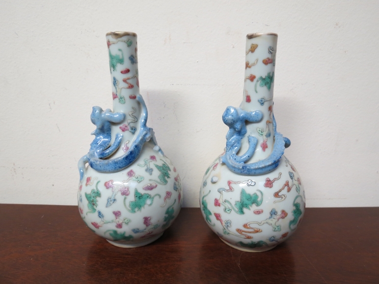 A pair of 19th Century Oriental china vases with dragon design, six character marks to base of each,