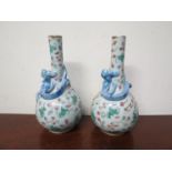 A pair of 19th Century Oriental china vases with dragon design, six character marks to base of each,