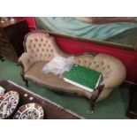 A Victorian carved rosewood chaise longue with beige button back upholstery and scrolled arms,