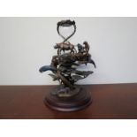 A bronze "Gaurdians of the world hourglass" figure by Steven D.