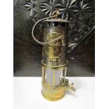 A brass and copper miner's lamp
