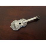 A white metal miniature guitar with engraved scenes, 10.