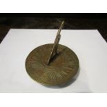 A brass sundial with gnomon,