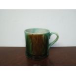 An early 19th Century Mocha Ware type mug with mixed green and brown glaze