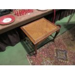 An early 20th Century carved stool on pad feet,