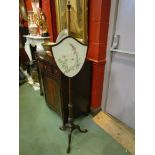 A 19th Century mahogany pole screen, foliate carved tripod base,