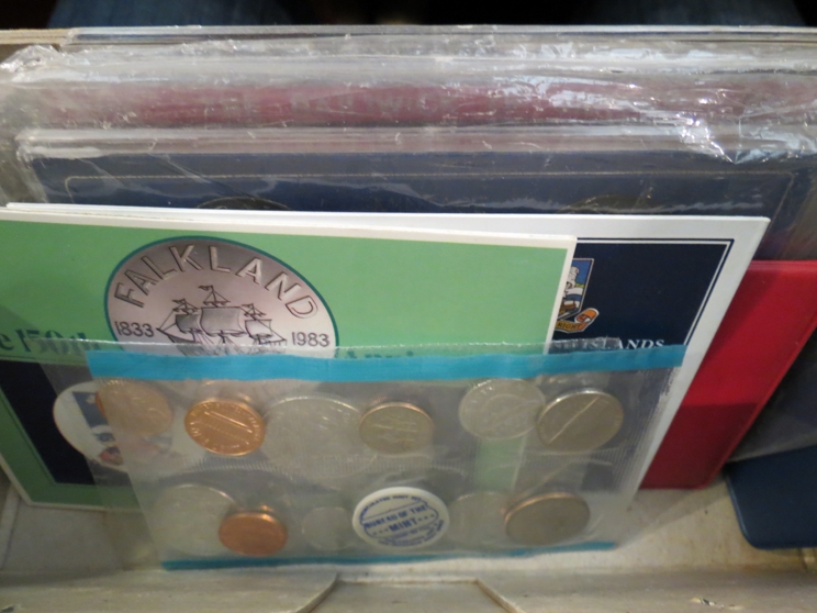 A box of cased proof and uncirculated coins from UK, Ireland, Jersey, Fiji, Australia,