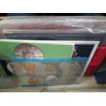 A box of cased proof and uncirculated coins from UK, Ireland, Jersey, Fiji, Australia,