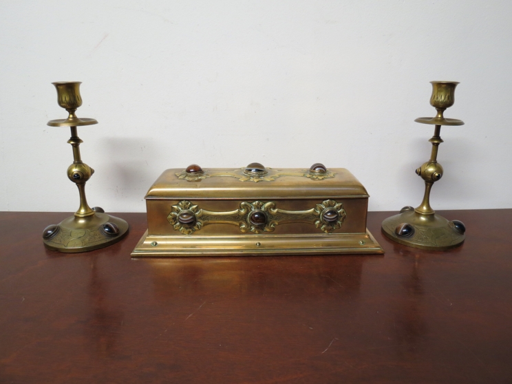 An ecclesiastical brass trinket box set with tiger's eye together wit a matched pair of