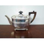 A Victorian Henry Stratford silver teapot with treen finial and handle, raised on ball feet,