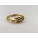 An 18ct gold five stone diamond ring with pierced setting