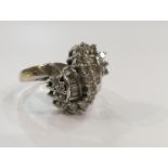 A 9ct white gold diamond cluster ring with round cut and baguette cut diamonds