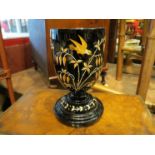 A 19th Century black glass goblet form vase with orange and white hand painted birds in foliage, 21.