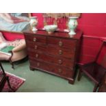 A George III cross banded mahogany chest of two short over three graduating long drawers on bracket