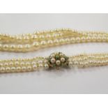A graduated three strand pearl necklace with 9ct gold clasp