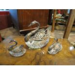 Three silver mounted swan cruets,