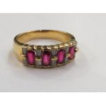 An 18ct gold ruby and diamond ring the four oval rubies set alternately with tapered diamonds