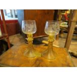 A pair of Schott Zwiesel wine goblets with amber ribbed stem,