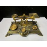 An Art Nouveau brass set of postal scales with four weights