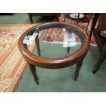 A Victorian mahogany circular top coffee table with glass inset top