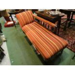 A chaise longue with striped upholstery