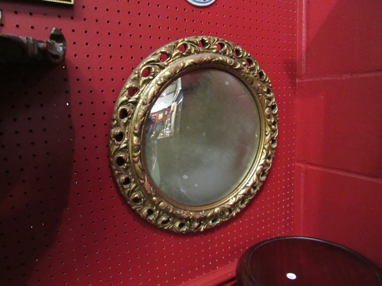 A circular gilt framed mirror