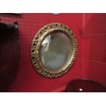 A circular gilt framed mirror