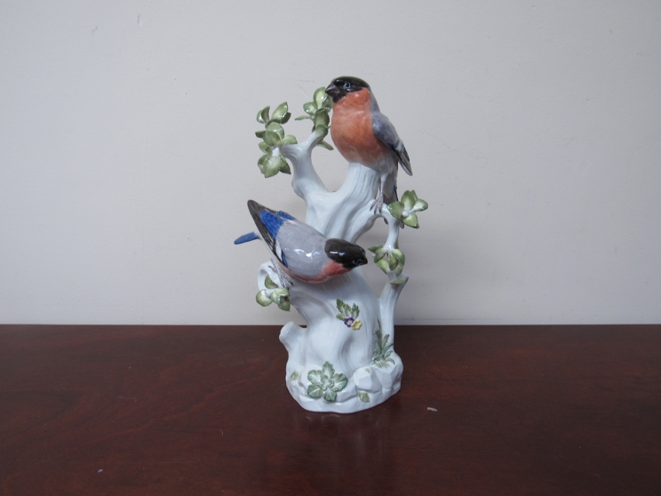 A Meissen marked porcelain figural group of two Bullfinches on a tree, base marked 850, 77286,