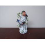 A Meissen marked porcelain figural group of two Bullfinches on a tree, base marked 850, 77286,