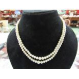 A double strand graduated pearl necklace with graduated five stone diamond set clasp,