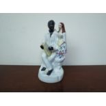 A 19th Century Victorian Staffordshire figure black servant with girl,