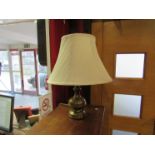 A brass table lamp and shade