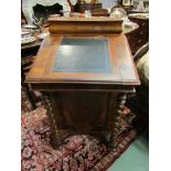 A 19th Century walnut davenport with inset leather slope, five side drawers,