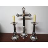 A pair of large faceted white metal candlesticks and matching crucifix