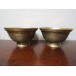 A pair of Chinese brass bowls with dragon decoration marks to base