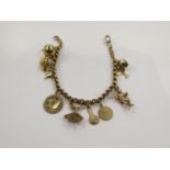 A 9ct gold charm bracelet hung with various charms including ballerina,