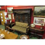 A 19th Century oak high-back settle with carved panel back, griffin arms, upholstered seat,